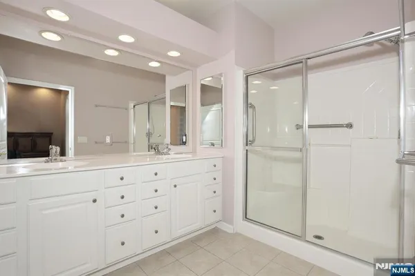 a bathroom with a shower sink and mirror