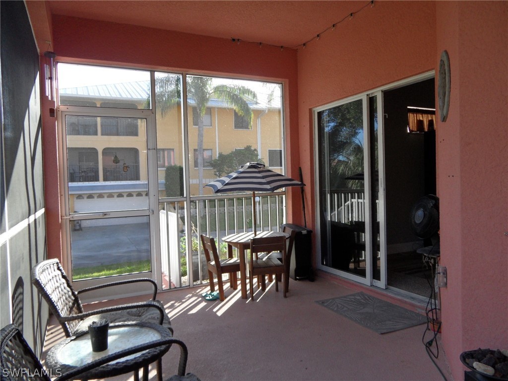 5430 Park Road, Unit 2 Fort Myers, FL 33908 - Photo 15 of 17 a balcony with table and chairs