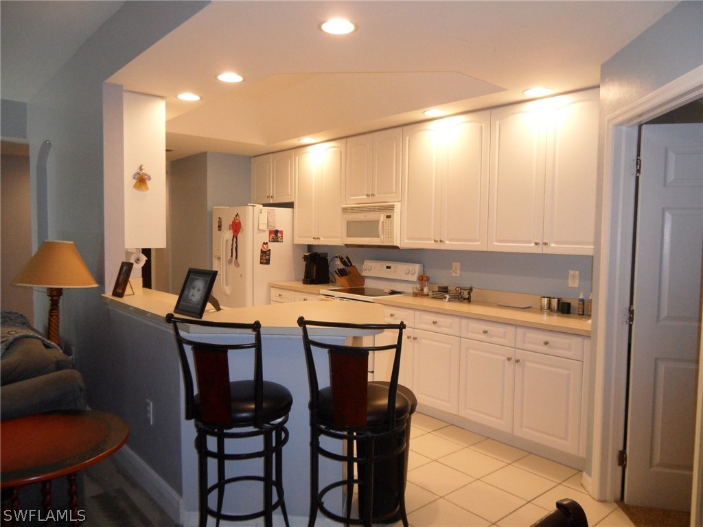5430 Park Road, Unit 2 Fort Myers, FL 33908 - Photo 4 of 17 a kitchen with stainless steel appliances kitchen island granite countertop a sink and cabinets