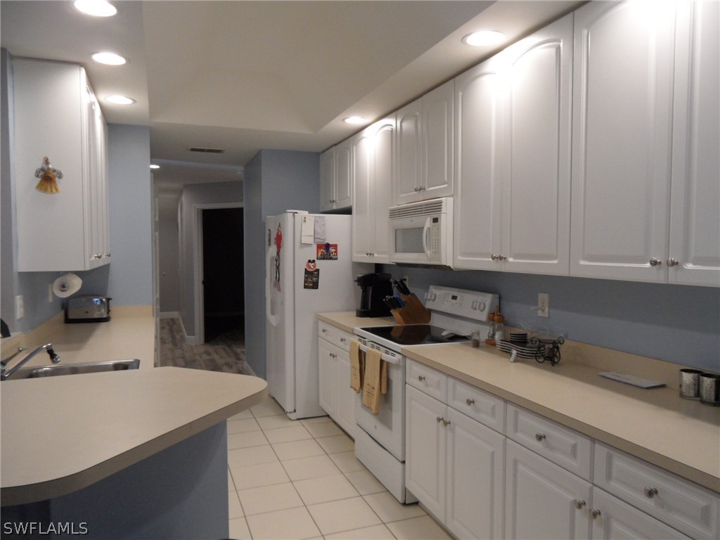 5430 Park Road, Unit 2 Fort Myers, FL 33908 - Photo 6 of 17 a kitchen with stainless steel appliances a sink stove and cabinets
