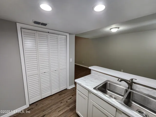 a view of storage and utility room with closet