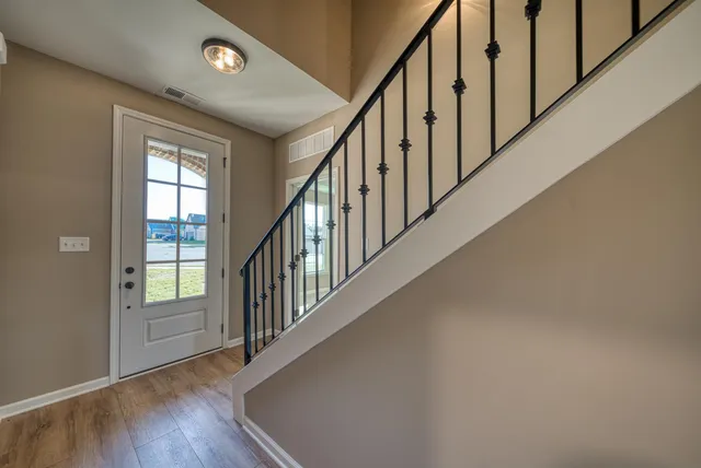 a view of an empty room with a ceiling fan and window