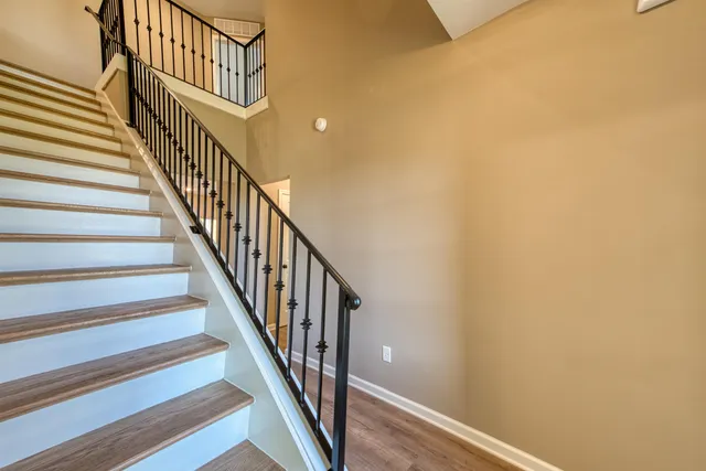 a spacious bathroom with a granite countertop sink toilet and a mirror