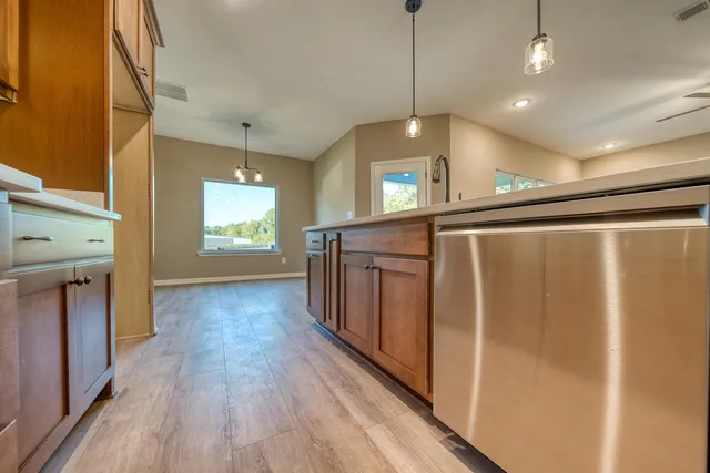 a view of a hallway with wooden floor and staircase