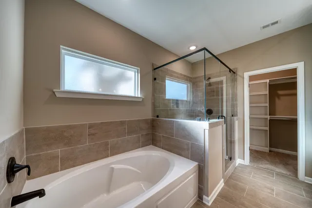 a bathroom with a bathtub and a shower