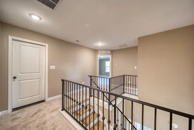 a view of staircase with rug floor