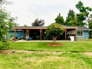 27225 Dave Road Canby, OR 97013 - Photo 2 of 31 a view of a house with a yard potted plants and large tree