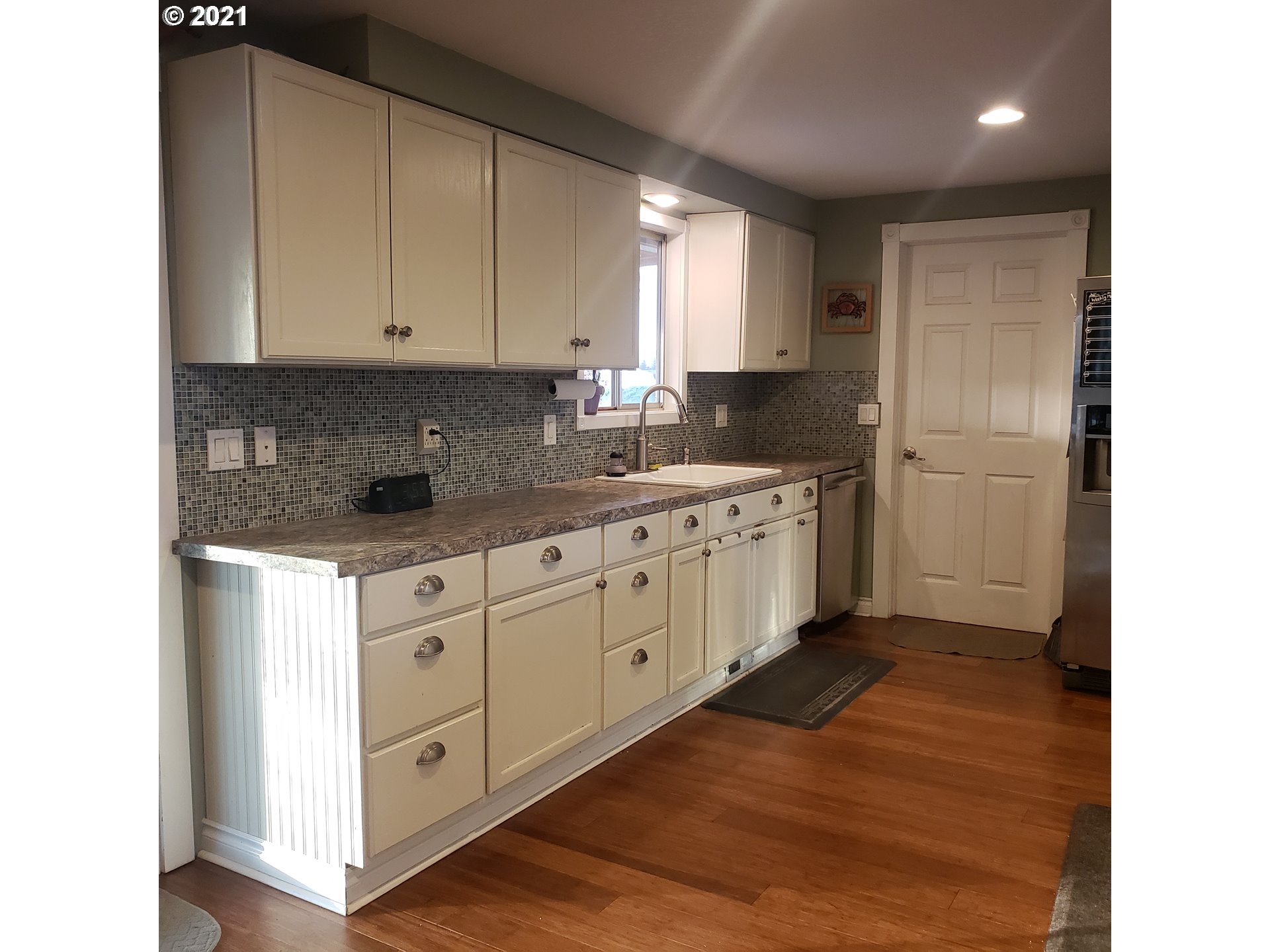 27225 Dave Road Canby, OR 97013 - Photo 6 of 31 a kitchen with white cabinets stainless steel appliances and sink
