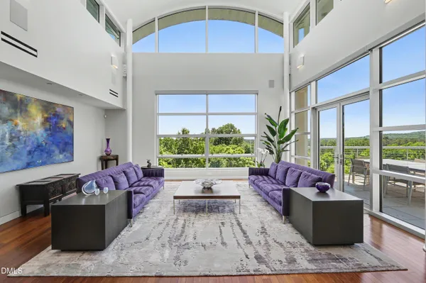 a living room with furniture fireplace and potted plant