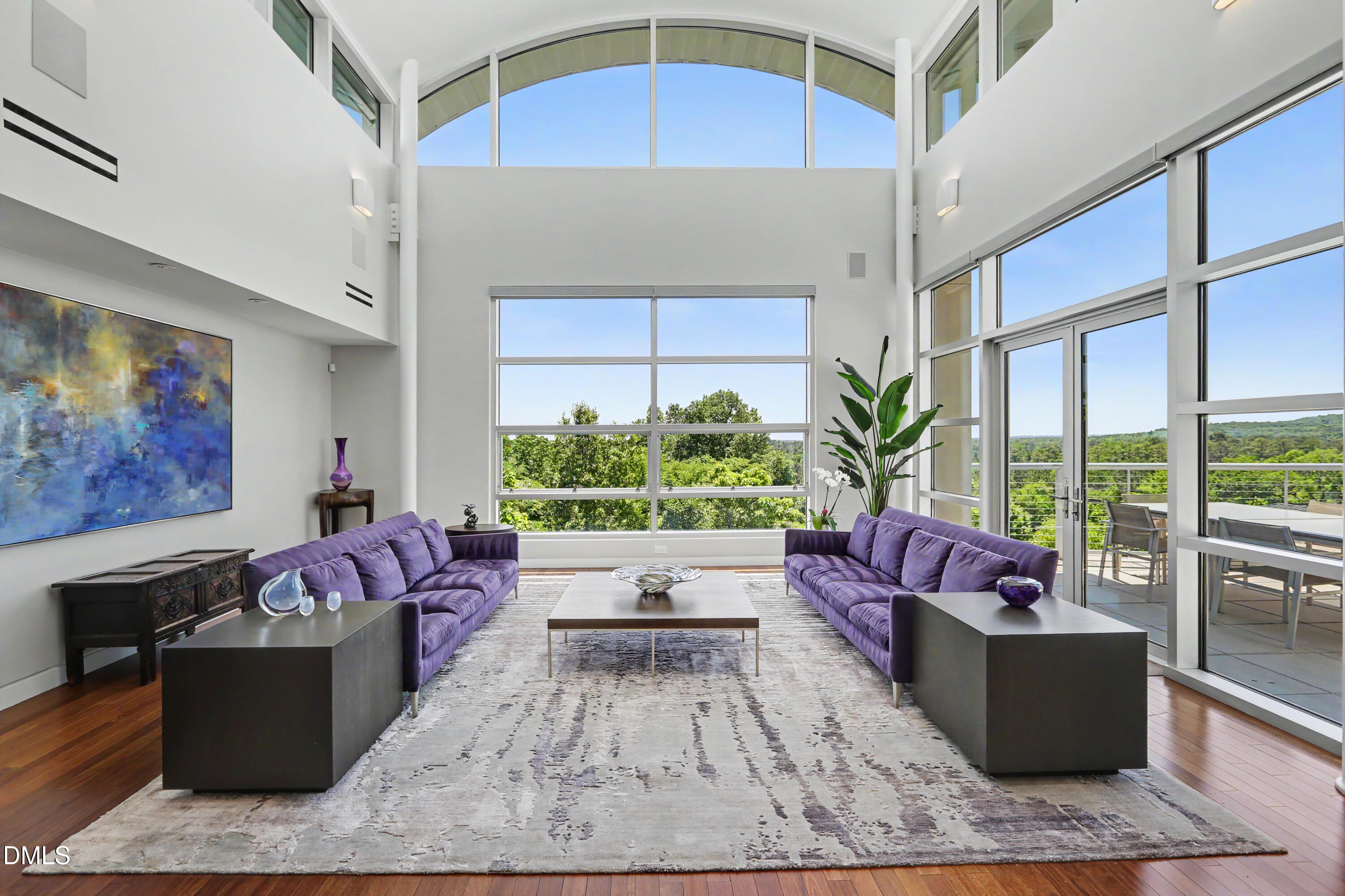 a living room with furniture fireplace and potted plant