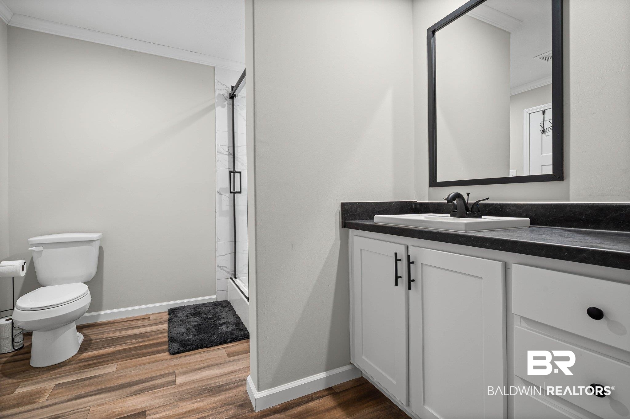 1325 Ridgewood Drive Lillian, AL 36549 - Photo 10 of 32 Full bath with vanity, a shower stall, dark wood-type flooring, and crown molding