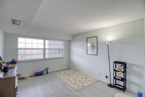 a bedroom with furniture and a wooden floor