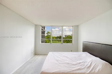 a bedroom with a bed and mirror