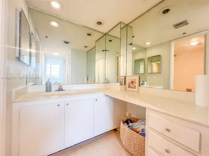 a white toilet and tub sitting next to a bathroom sink