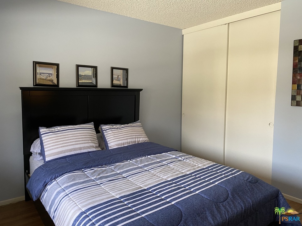 1268 Ramon Road, Unit 22 Palm Springs, CA 92264 - Photo 16 of 21 a bedroom with a bed and a window