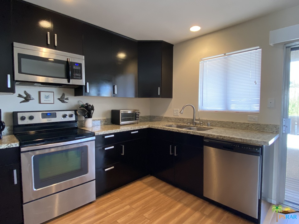 1268 Ramon Road, Unit 22 Palm Springs, CA 92264 - Photo 3 of 21 a kitchen with a sink stove and microwave