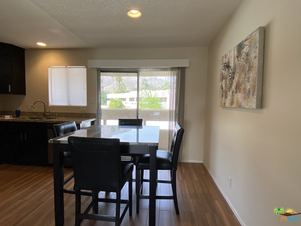 1268 Ramon Road, Unit 22 Palm Springs, CA 92264 - Photo 5 of 21 a view of a a dining room with furniture window and wooden floor