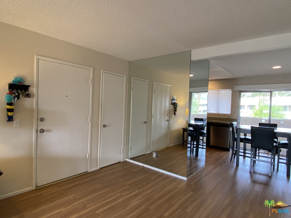 1268 Ramon Road, Unit 22 Palm Springs, CA 92264 - Photo 7 of 21 a view of a dining room with furniture window and wooden floor