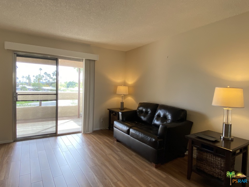 1268 Ramon Road, Unit 22 Palm Springs, CA 92264 - Photo 8 of 21 a living room with furniture and a lamp