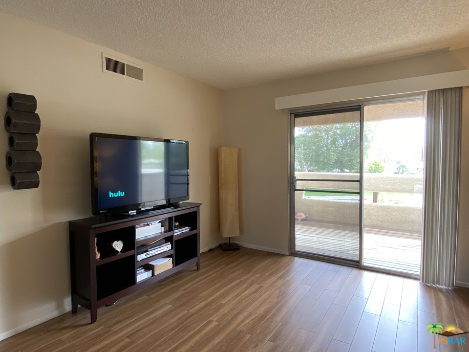 1268 Ramon Road, Unit 22 Palm Springs, CA 92264 - Photo 10 of 21 a living room with furniture and a flat screen tv
