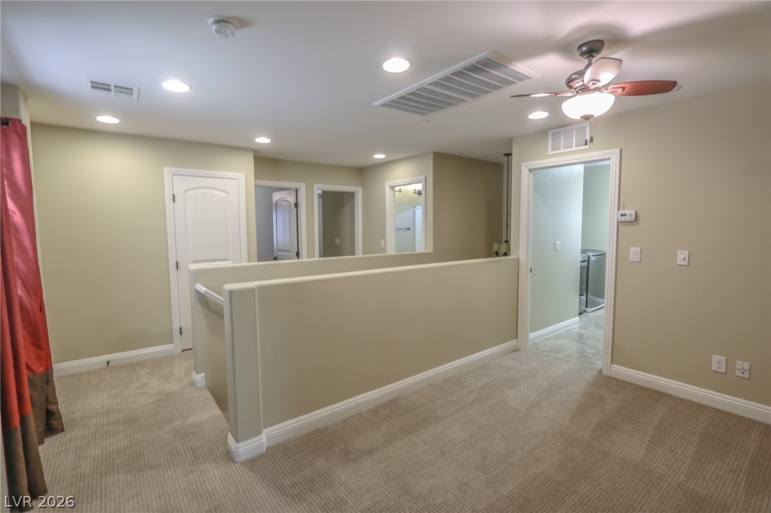 1509 Destiny Ridge Court Henderson, NV 89074 - Photo 15 of 29 A spacious upper-level landing features soft wall-to-wall carpeting and multiple entryways to adjacent rooms.