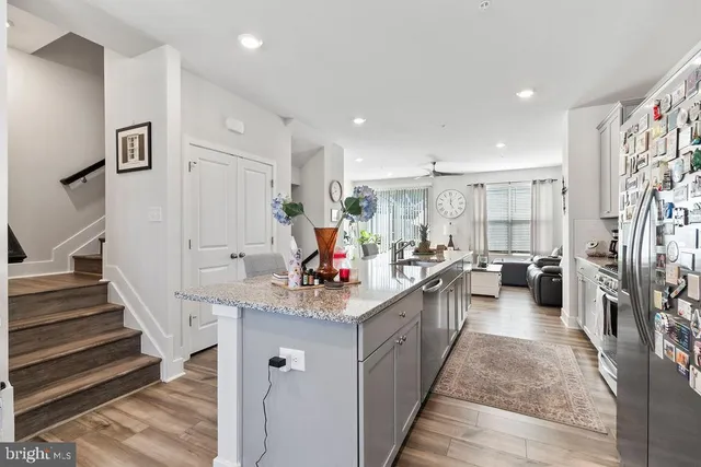 a kitchen with counter top space sink stove and refrigerator