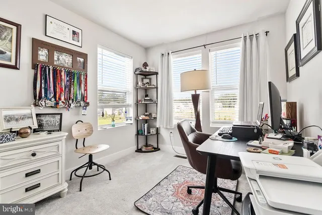a living room with furniture a flat screen tv and a window