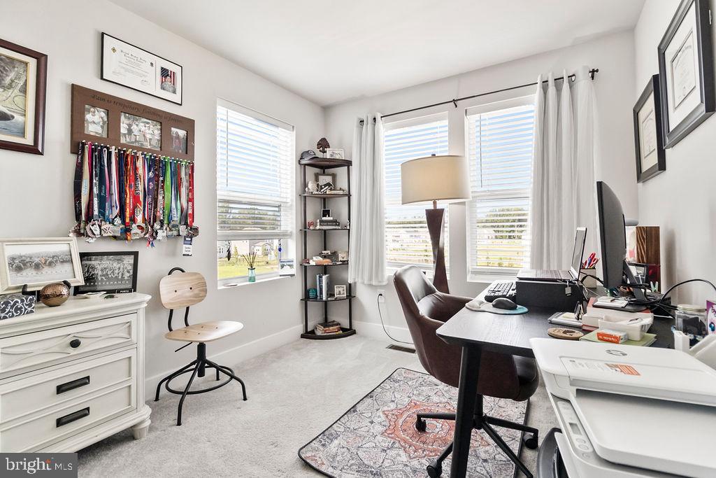6882 Barrowfield Place Bryans Road, MD 20616 - Photo 16 of 34 a living room with furniture a flat screen tv and a window