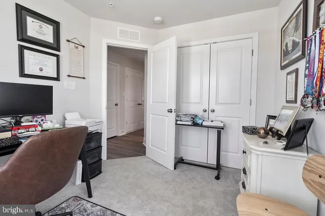 a view of a workspace with furniture and a flat screen tv