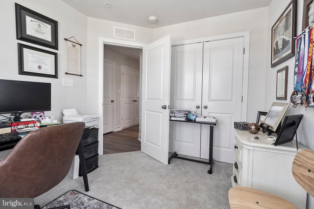 6882 Barrowfield Place Bryans Road, MD 20616 - Photo 19 of 34 a view of a workspace with furniture and a flat screen tv