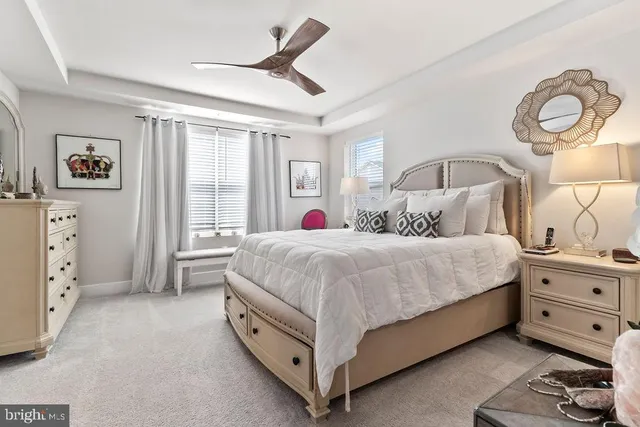 a spacious bedroom with a bed and a cabinets