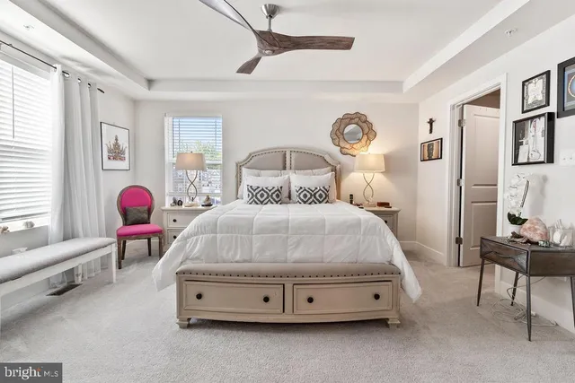 a spacious bedroom with a bed and a chandelier