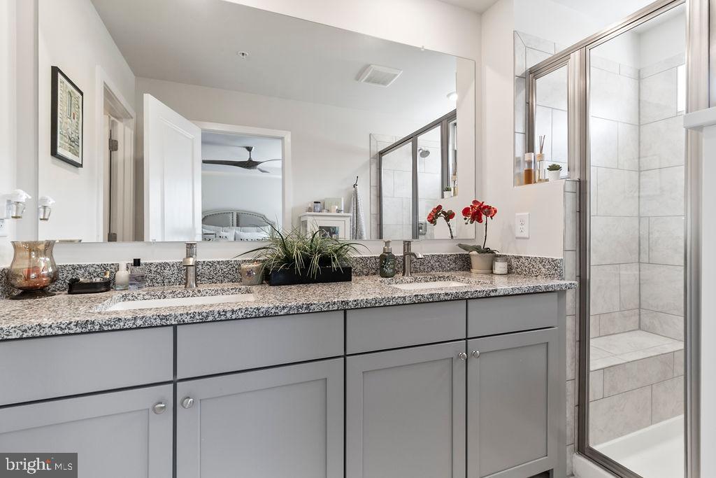 6882 Barrowfield Place Bryans Road, MD 20616 - Photo 25 of 34 a bathroom with a granite countertop sink double vanity and a mirror