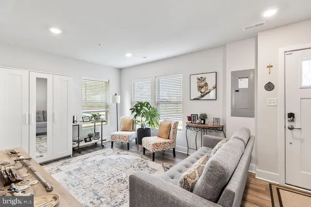 a living room with furniture and wooden floor