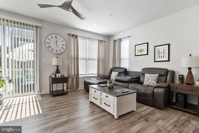 a living room with furniture a wooden floor and a window