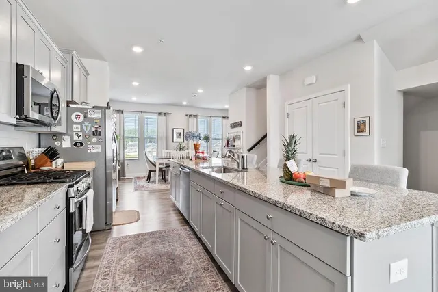 a kitchen with counter top space a sink appliances and cabinets
