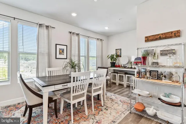 a dining room with furniture and a window