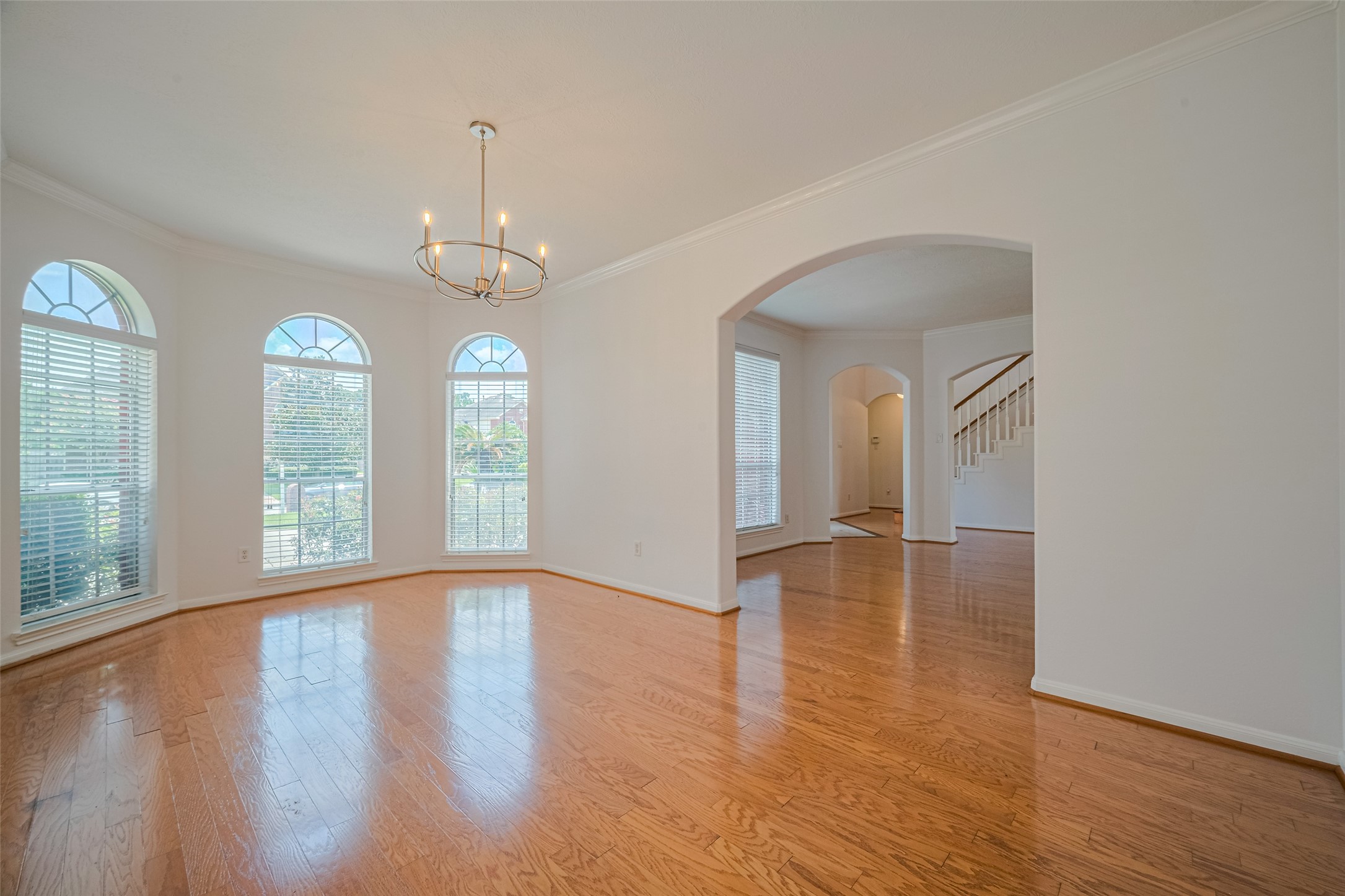 9218 Memorial Pines Way Spring, TX 77379 - Photo 16 of 39 Elegant dining room with arched windows perfect for hosting gatherings.