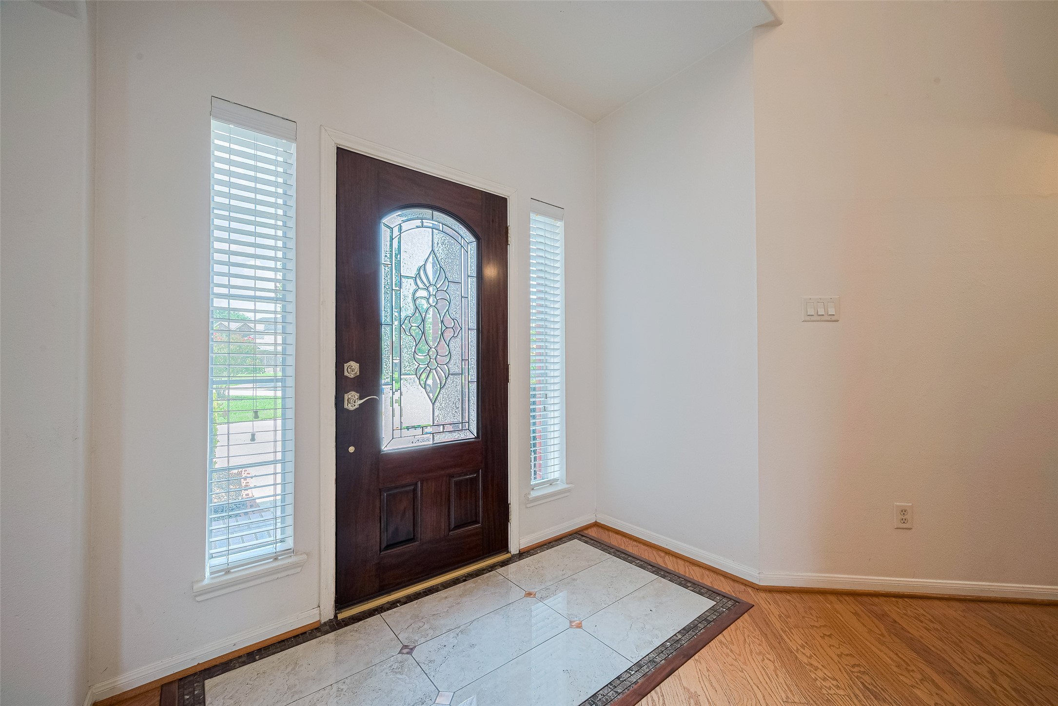 9218 Memorial Pines Way Spring, TX 77379 - Photo 4 of 39 Experience a warm welcome with this elegant front door, featuring exquisite glass detailing and abundant natural light.