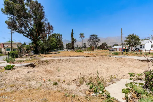 an aerial view of residential houses with city view