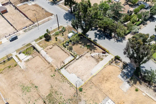 an aerial view of a house with a yard and trees