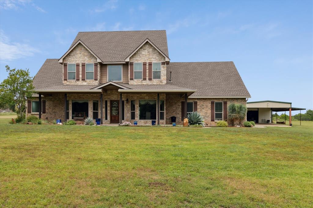 a front view of a house with a garden