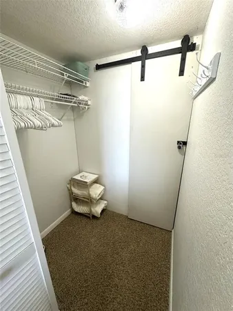 a bedroom with two beds and a flat screen tv