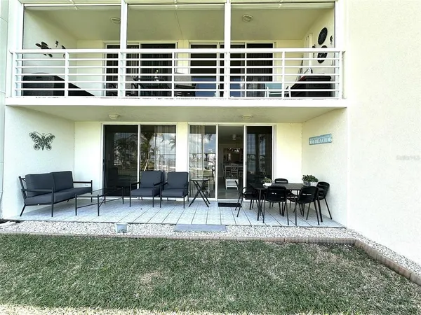 a backyard of a house with table and chairs
