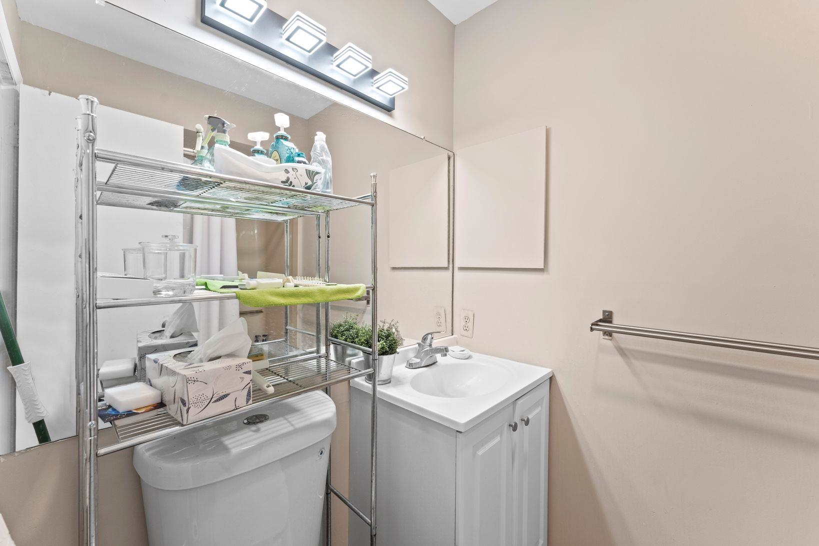 601 River Renaissance East Rutherford, NJ 07073 - Photo 19 of 26 a bathroom with a sink a toilet and a mirror