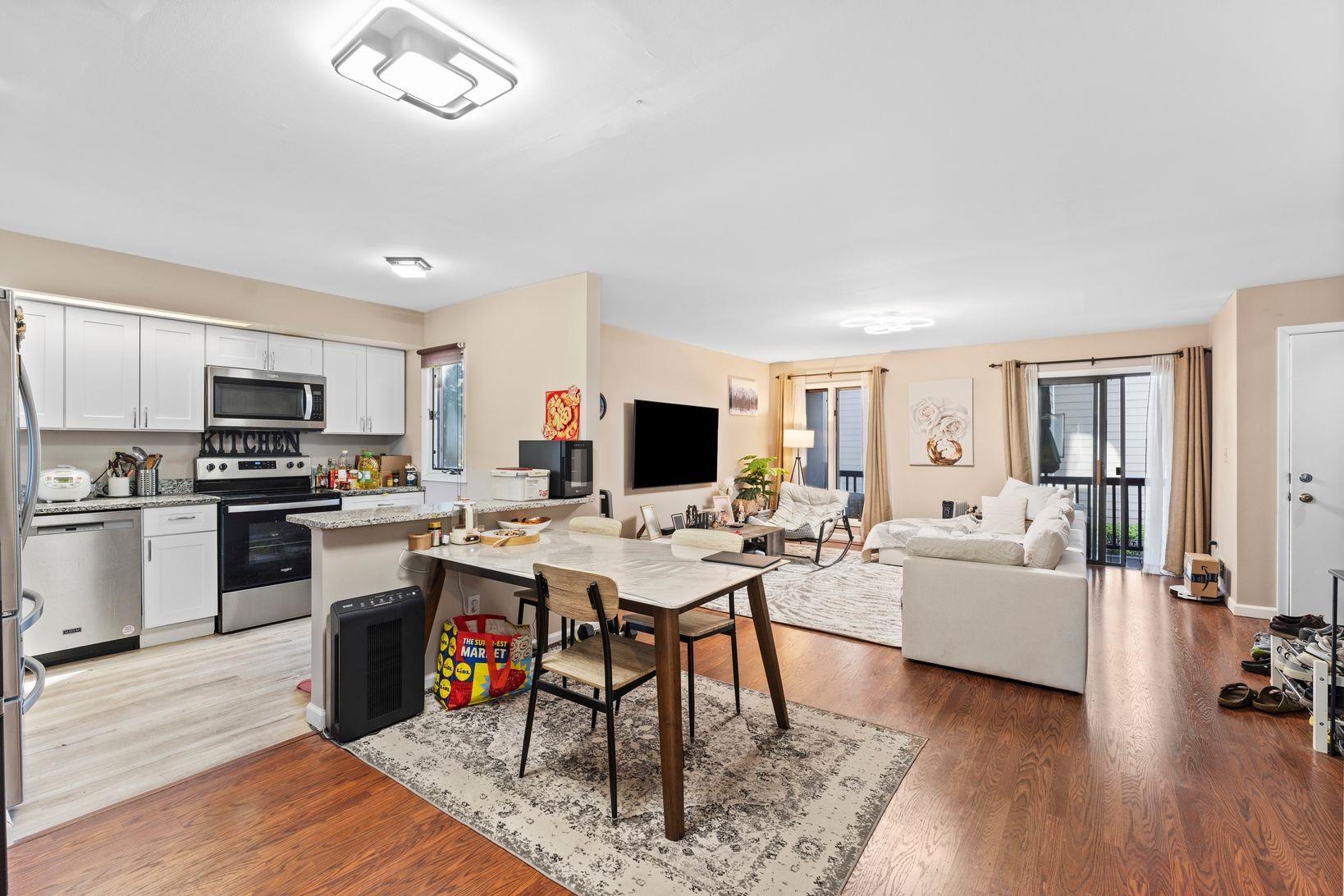 601 River Renaissance East Rutherford, NJ 07073 - Photo 5 of 26 a living room with furniture a flat screen tv and kitchen view