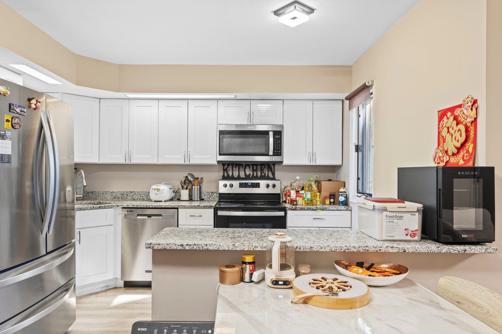 601 River Renaissance East Rutherford, NJ 07073 - Photo 7 of 26 a kitchen with a refrigerator and a stove top oven
