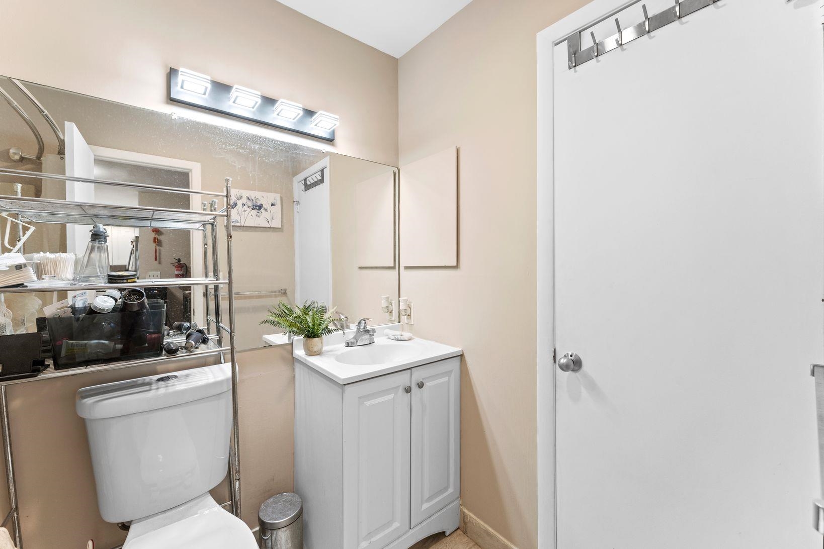 601 River Renaissance East Rutherford, NJ 07073 - Photo 10 of 26 a bathroom with a sink a toilet a mirror and shower