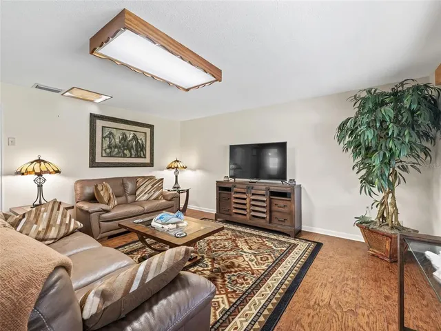 a view of a livingroom with furniture and a flat screen tv
