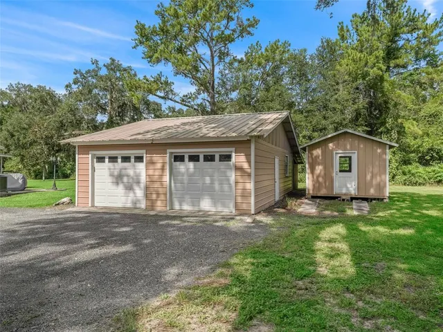 a view of house with outdoor space and parking